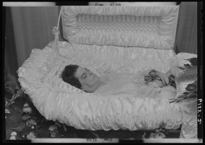 Foley, Mrs. Edward(?); corpse; open casket surrounded by flowers;                             photographs requested by Mrs. Edward Burden (359 South                             Spring)