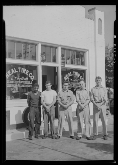 Neal Tire Company (service station, gas station), 12th (twelfth)                             & Limestone; exterior; five (5) employee standing in front of                             building; group portrait