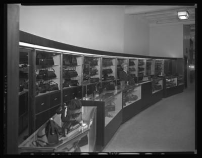 Mitchell, Baker & Smith Company (clothing), 230-232 West                             Main; interior; sales lady standing behind display counter