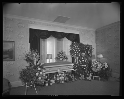 Ben Dotson (Police Officer); corpse; closed casket surrounded by                             flowers