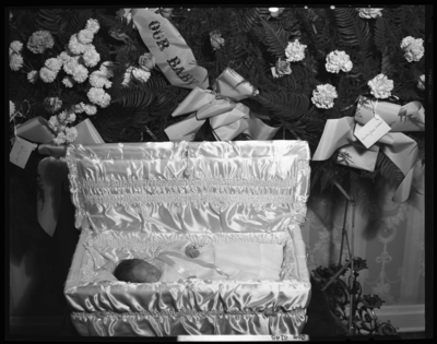 Marion Weber; corpse (baby); open casket surrounded by                             flowers