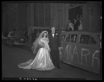 Mr. & Mrs. Ronald Lee Cole; wedding; exterior; bride and                             groom standing beside car parked in front of unidentified                             church