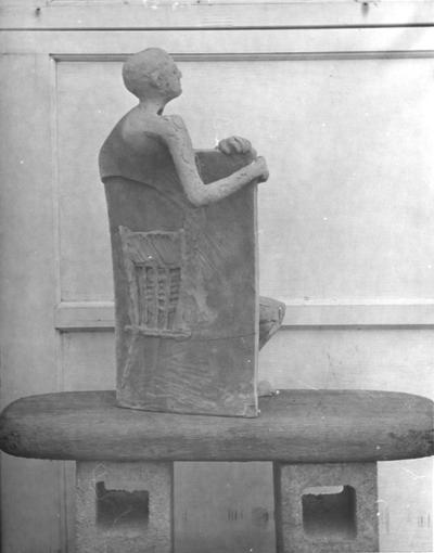 The back of a ceramic sculpture, a human form mixed with a chair shape, by John Tuska
