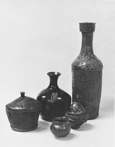 Five ceramic pots by John Tuska. Two of the pots have lids
