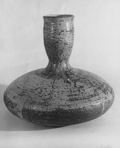 A ceramic vase with a round fat bottom by John Tuska