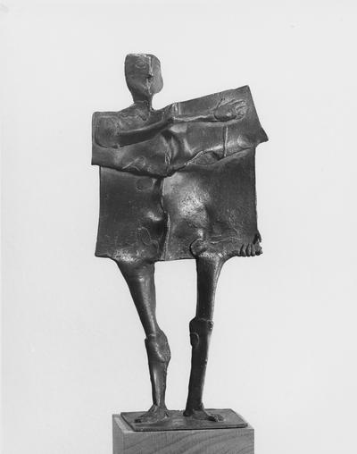 A bronze slab figure sculpture with a walnut base by John Tuska. This is one of the Italy inspired bronzes created during and after Tuska's trip to Italy in 1969. This is the same sculpture as images 77 and 76