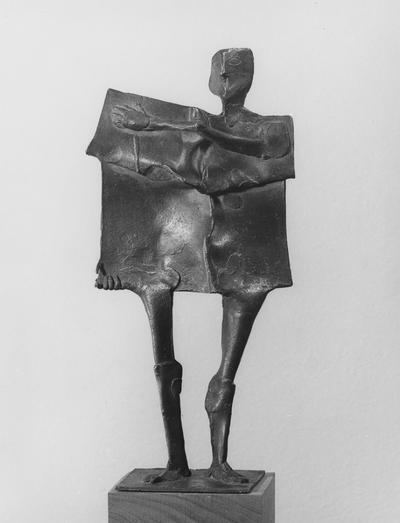 A bronze slab figure sculpture with a walnut base by John Tuska. This is one of the Italy inspired bronzes created during and after Tuska's trip to Italy in 1969. Reverse print of image 75. This is the same sculpture as images 75 and 77