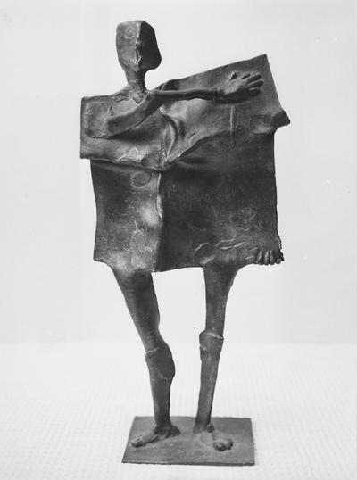 A bronze slab figure sculpture by John Tuska. This is one of the Italy inspired bronzes created during and after Tuska's trip to Italy in 1969. This is the same sculpture as images 75 and 76
