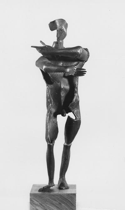 A bronze male nude sculpture with a walnut base entitled 