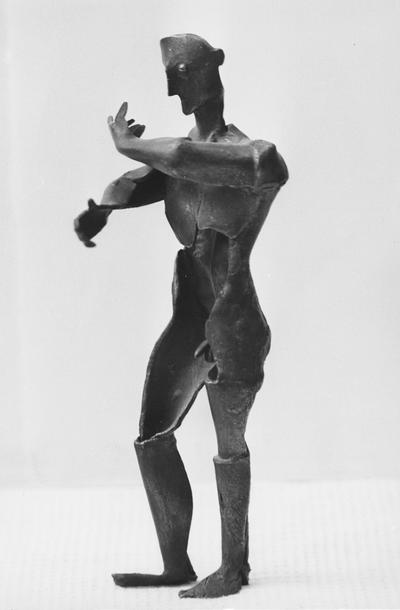 A bronze male nude sculpture with a walnut base entitled 