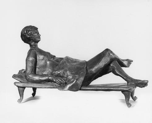 A bronze sculpture of a female figure entitled 