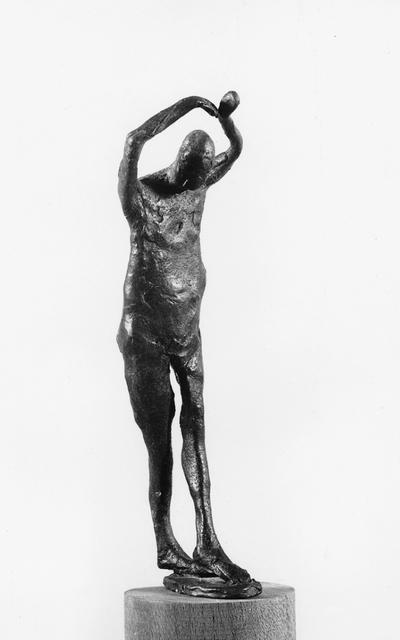 A bronze sculpture of a male nude with a walnut base and green patina entitled 