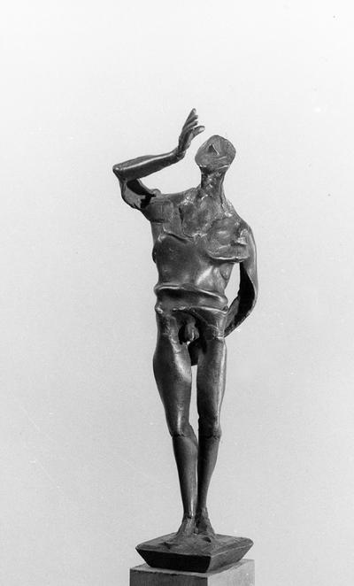 A bronze sculpture of a male nude with a walnut base entitled 