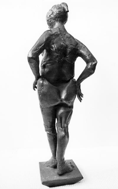 A view of the back of a bronze sculpture of a female nude entitled 