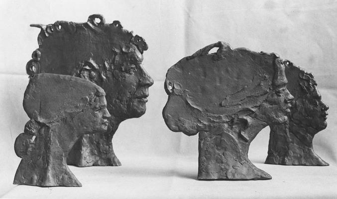 Four ceramic heads in profile by John Tuska