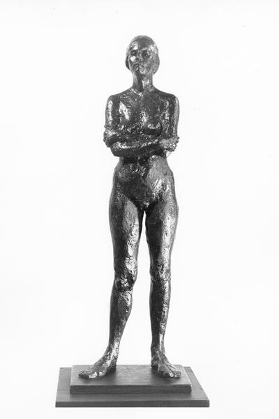 A fiberglass life size sculpture of a female nude standing with her arms crossed by John Tuska. The model's name is Pat. This is the same piece as in image 167