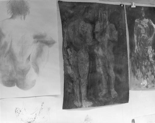 Pencil and ink drawings of human figures hanging on a wall by John Tuska
