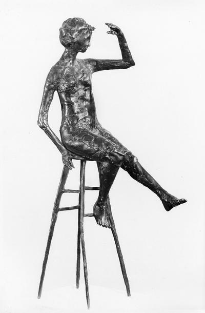 A bronze sculpture of a female nude mounted on travertine marble entitled 