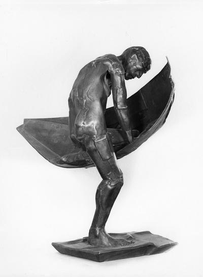 A bronze sculpture of a male nude entitled 