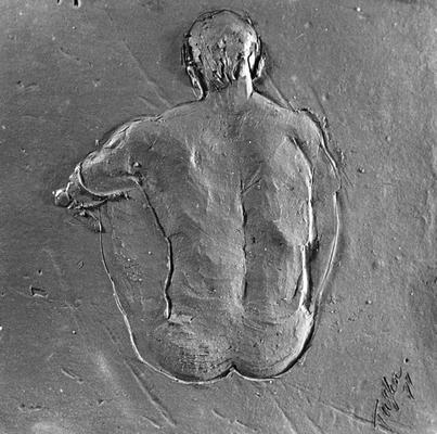 A ceramic tile relief of the back of a male nude by John Tuska