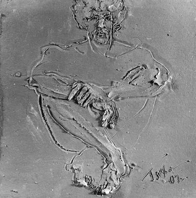 A ceramic tile relief of a male nude by John Tuska