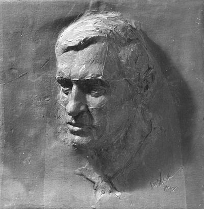 A ceramic tile relief of a man's head by John Tuska. The man depicted in this piece is Joe Davis, a personal friend of John Tuska
