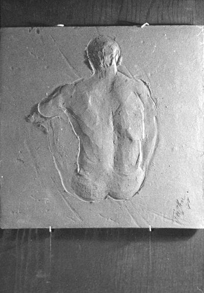 A ceramic tile relief of the back of a male nude by John Tuska