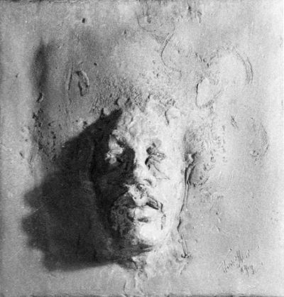 A ceramic tile relief of a male head entitled 