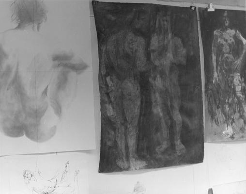 Pencil and ink drawings of human figures hanging on a wall by John Tuska