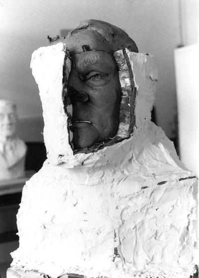 An image of plaster being removed from a John Sherman Cooper bust by John Tuska