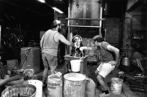 John Tuska and Jack Gron applying plaster to a wax mold of the John Sherman Cooper bust