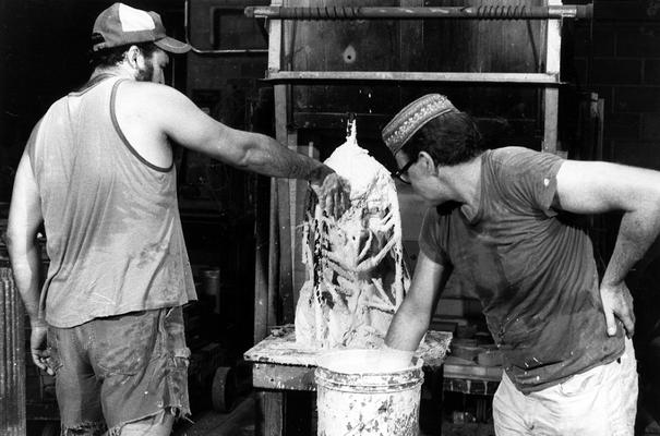 John Tuska and Jack Gron applying plaster to a wax mold of the John Sherman Cooper bust