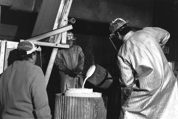 John Tuska, unidentified man and Jack Gron pouring bronze in the mold for the John Sherman Cooper bust