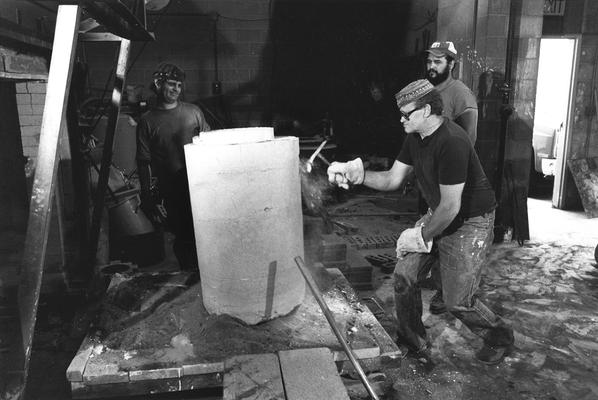 An unidentified man, John Tuska and Jack Gron opening the John Sherman Cooper bust mold