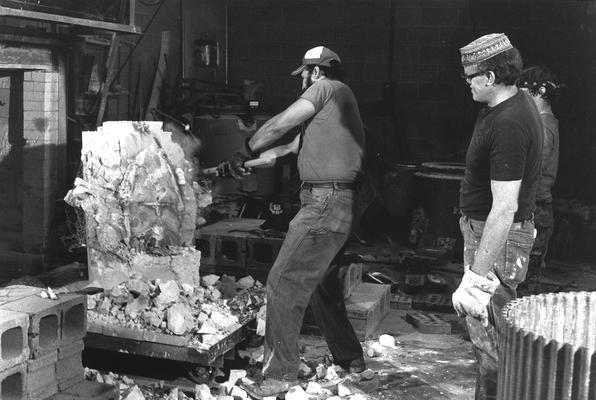 Jack Gron, John Tuska and an unidentified man opening the John Sherman Cooper bust mold