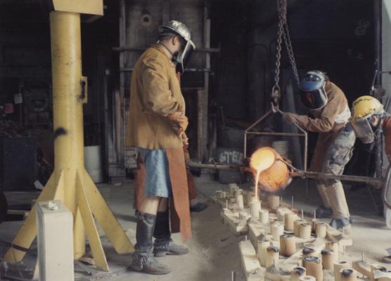 Jack Gron, Scott Oberlink and Andrew Marsh pouring bronze in the University of Kentucky foundry for 