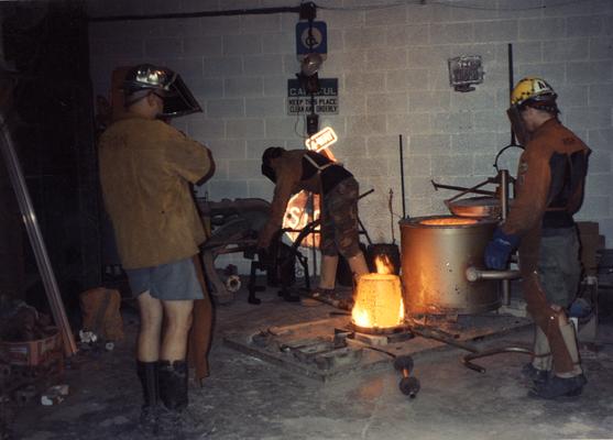 Jack Gron, Scott Oberlink and Andrew Marsh preparing to pour bronze in the University of Kentucky foundry for the casting of 