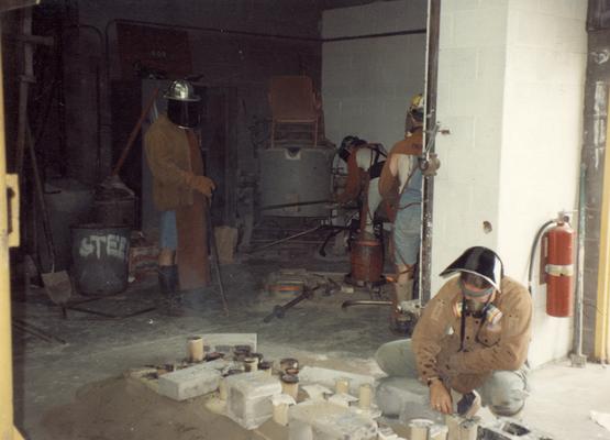 Jack Gron, an unidentified man, Andrew Marsh and Scott Oberlink after pouring bronze in the University of Kentucky foundry for the casting of 