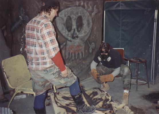 Andrew Marsh and Scott Oberlink breaking apart a sand mold in the University of Kentucky foundry during the casting 