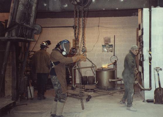 Jack Gron, Scott Oberlink and two unidentified men working in the University of Kentucky foundry during the casting of 