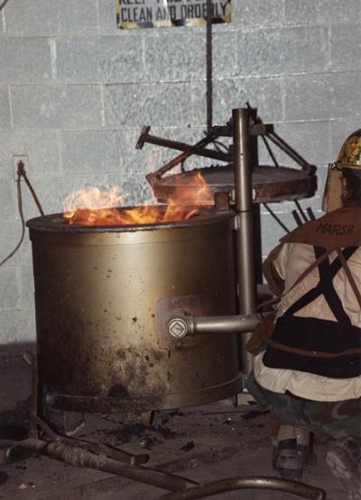Andrew Marsh near the furnace in the University of Kentucky foundry during the casting of 