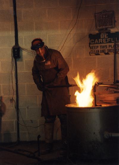 Scott Oberlink working with the furnace at the University of Kentucky foundry during the casting of 