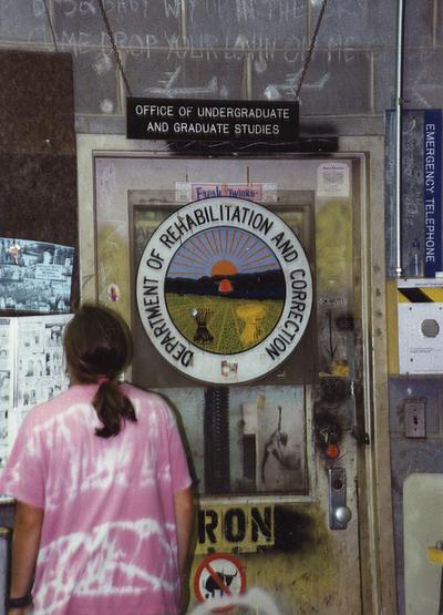 An unknown man in front of the entrance to Jack Gron's office in the University of Kentucky foundry during the casting of 