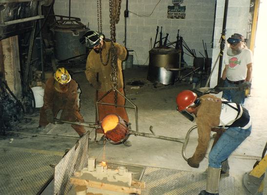 Andrew Marsh, Jack Gron, Scott Oberlink and an unidentified man pouring bronze at the University of Kentucky foundry for the casting of 