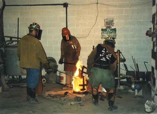 Jack Gron, Scott Oberlink and Andrew Marsh getting ready to pour bronze at the University of Kentucky foundry for the casting of 