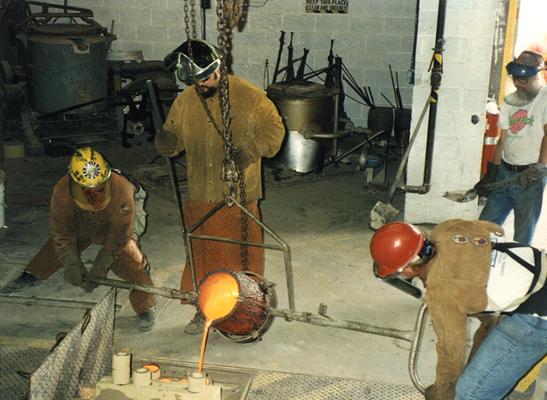 Andrew Marsh, Jack Gron, Scott Oberlink and an unidentified man pouring bronze at the University of Kentucky foundry for the casting of 