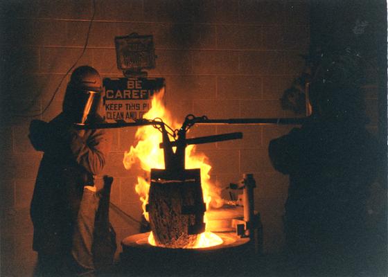 Scott Oberlink and Andrew Marsh putting the crucible in the furnace at the University of Kentucky foundry for the casting of 