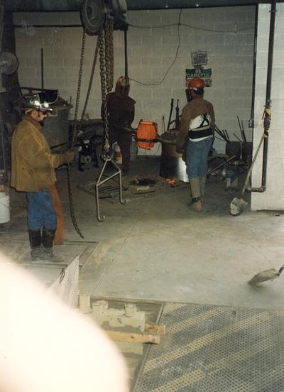 Jack Gron, Andrew Marsh and Scott Oberlink getting ready to pour bronze at the University of Kentucky foundry for the casting of 