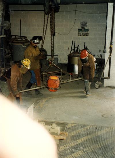 Andrew Marsh, Jack Gron and Scott Oberlink getting ready to pour bronze at the University of Kentucky foundry for the casting of 