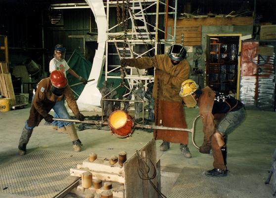 Scott Oberlink, an unidentified man, Jack Gron and Andrew Marsh pouring bronze at the University of Kentucky foundry for the casting of 